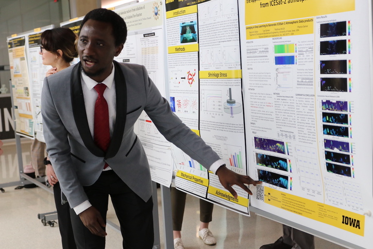 A researcher discusses his poster