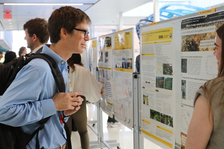 A person looking at a research poster