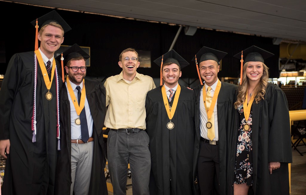 Group of students in graduation caps and gowns