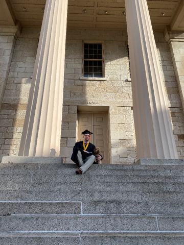 Ryan Konecni on the steps of the Old Capitol in Iowa City.