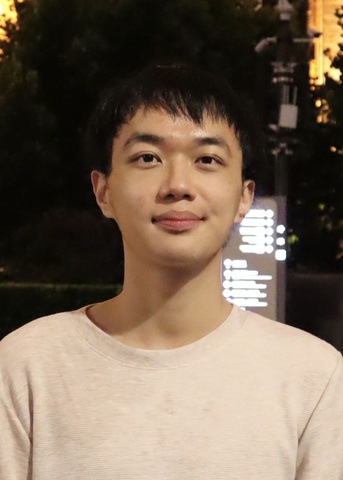 Portrait. Man with dark hair and white shirt.