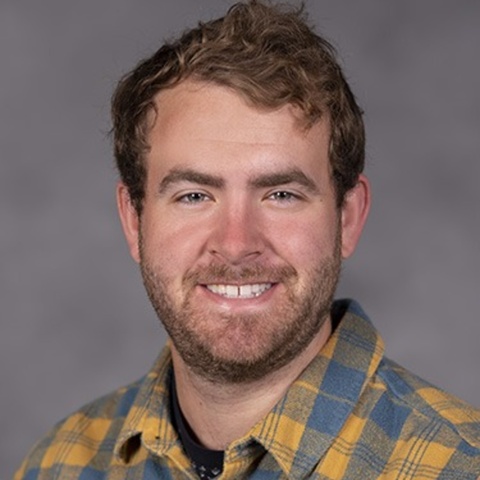Head shot of male student with brown hair and beard