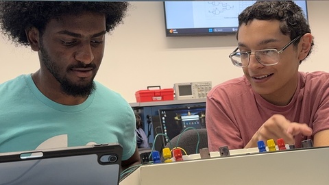 Two students at a lab bench in Digital Design class