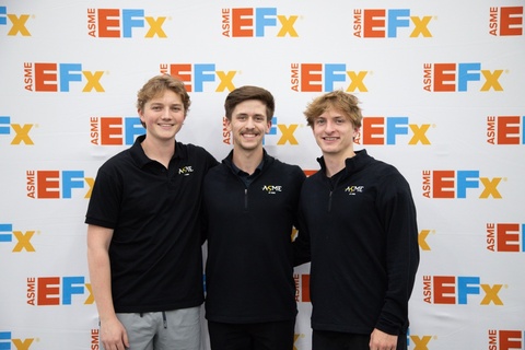 Three students wearing ASME-branded shirts stand in front of an ASME E-Fest backdrop, posing for a photo at an engineering conference or competition.