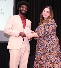 Basil Saeed receiving Outstanding Student Organization Leader award from Alyssa Burks
