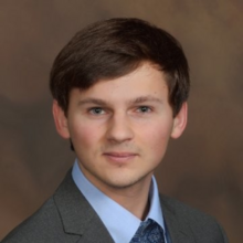 Portrait of man with dark hair and suit