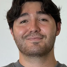 Closeup of man with dark hair and stubble