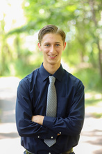 Man with blond hair from waist up