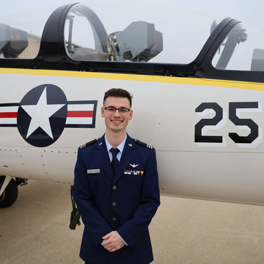 Isaac Eigner-Bybee standing in front of a small airplane