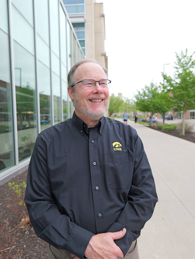 Rick Fosse stands smiling outside the Seamans Center