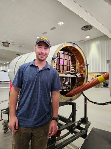 Graduate student Grant Finneman stands in front of the Cloud Physics Lidar (CPL) instrument prior it to being mounted on the ER-2 high-altitude research aircraft