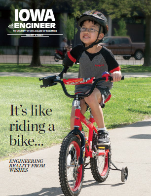 magazine cover. young child riding his red bike
