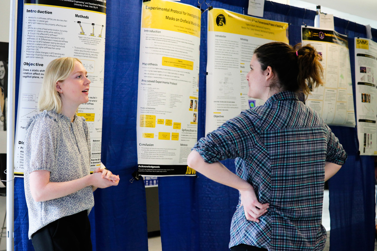 Student speaks with faculty member