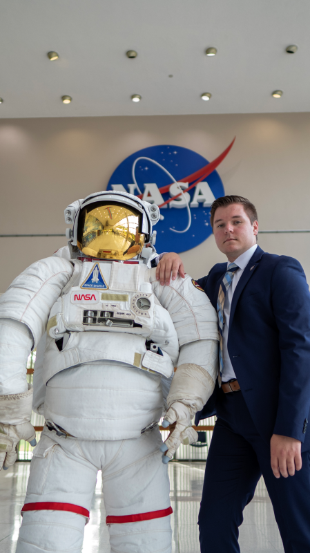 Mat McDonnell poses with an astronaut statue