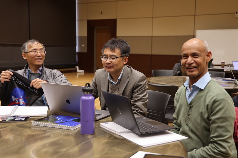 Three people at a table in a meeting room