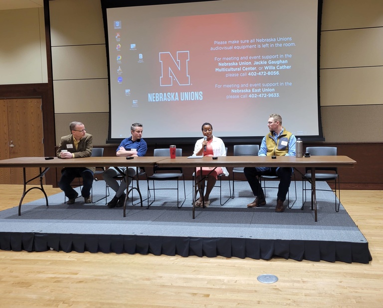 Four presenters at a table