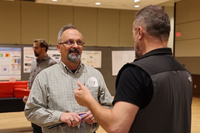 Two people talking at a conference