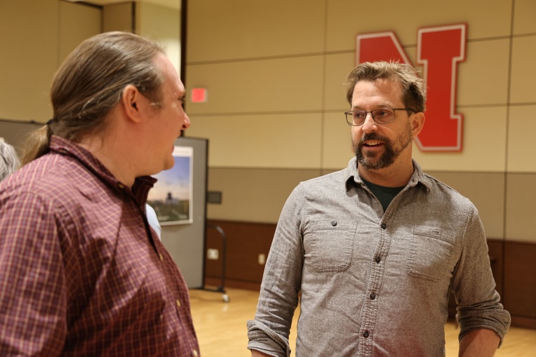 Two people talking at a conference