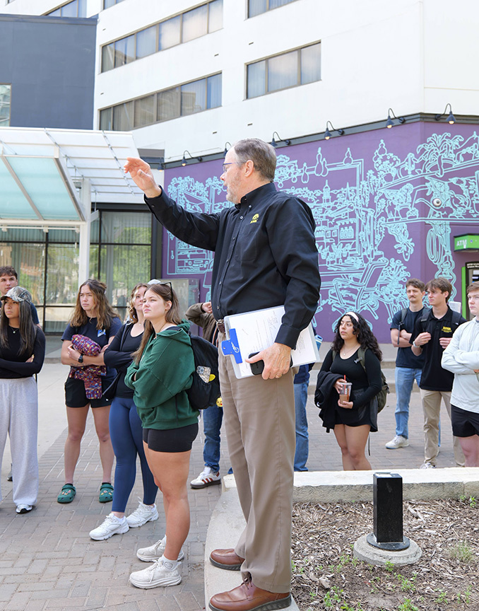 Rick Fosse leads students in the Resilient Infrastructure Emergency Response class on a field trip through downtown Iowa City to explore multipurpose infrastructure.