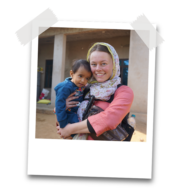 Sydney Parks holds a small child in India