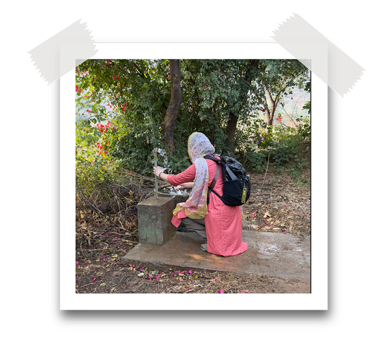 kneeling at a water fountain