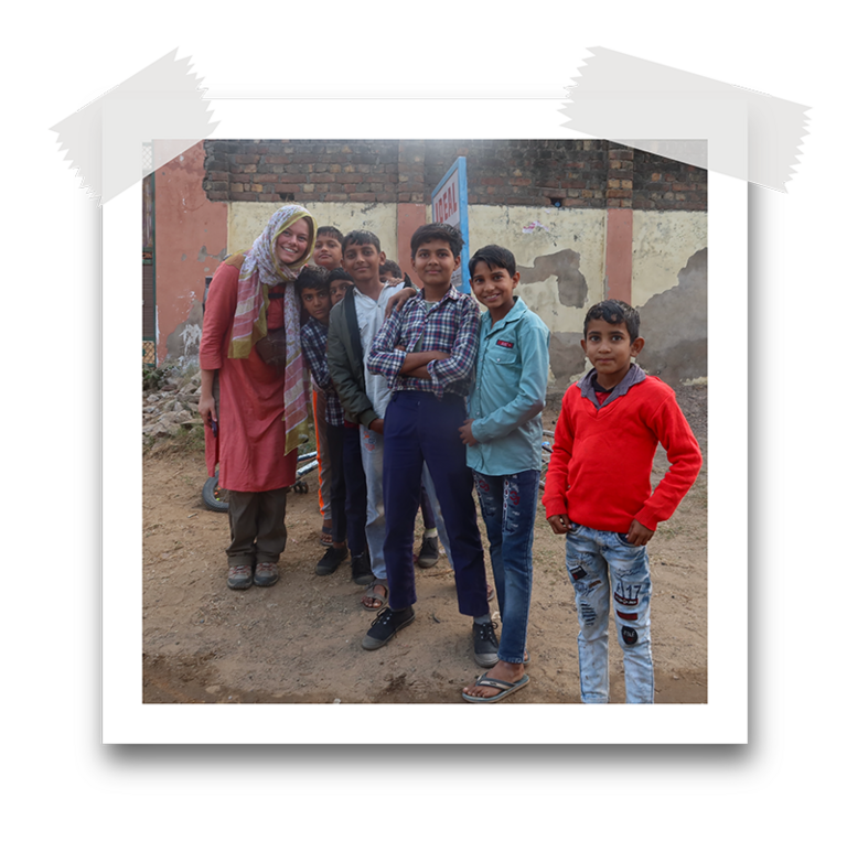 Sydney Parks poses with local school children