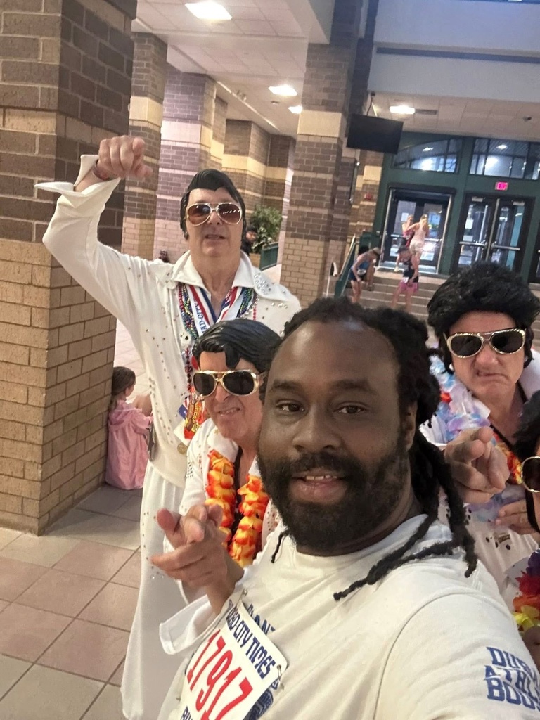 A man with Elvis impersonators