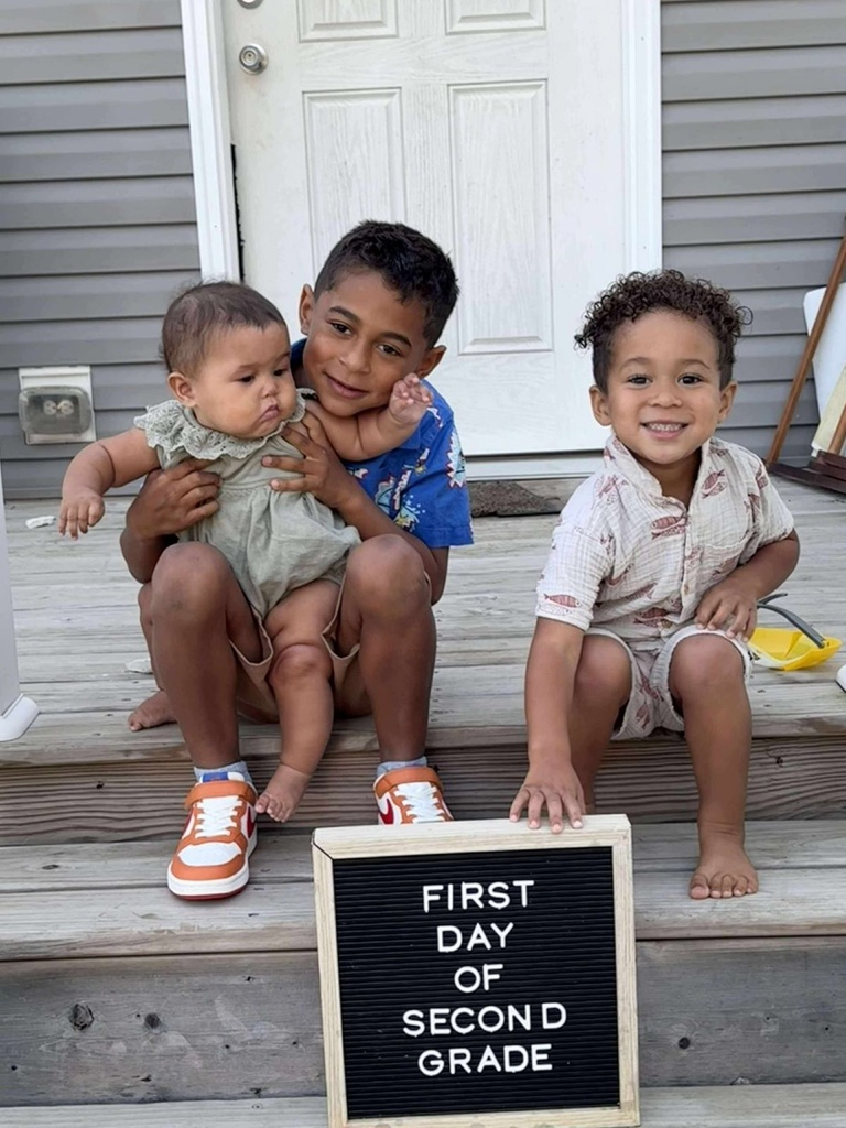 Three kids on a front step