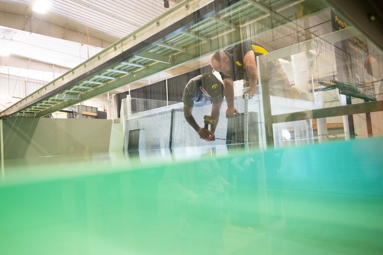 Two people working on a water tank