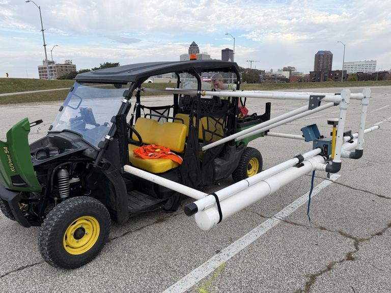 UTV with mounted PVC pipe parked in parking lot