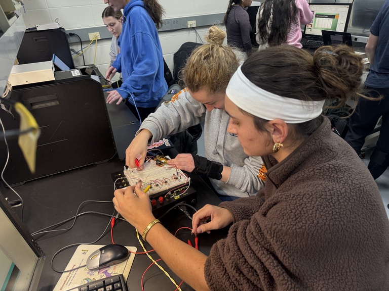Two students work on project at lab bench