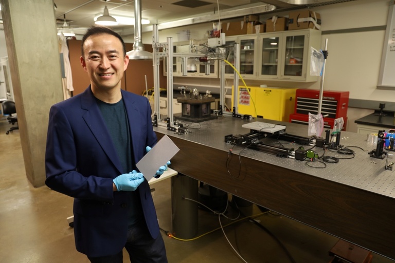 Ding holds a laser-processed sample produced using the nHSN method.