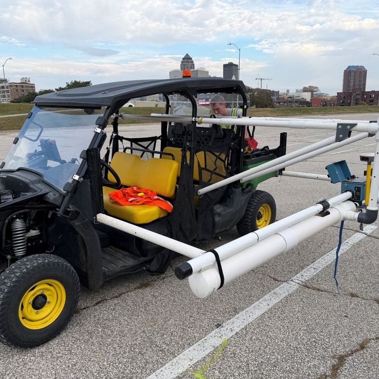 UTV with mounted PVC pipe parked in parking lot