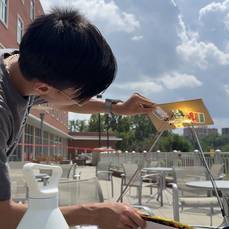 Leung observes the amount of light concentrated by his solar thermophotovoltaic system
