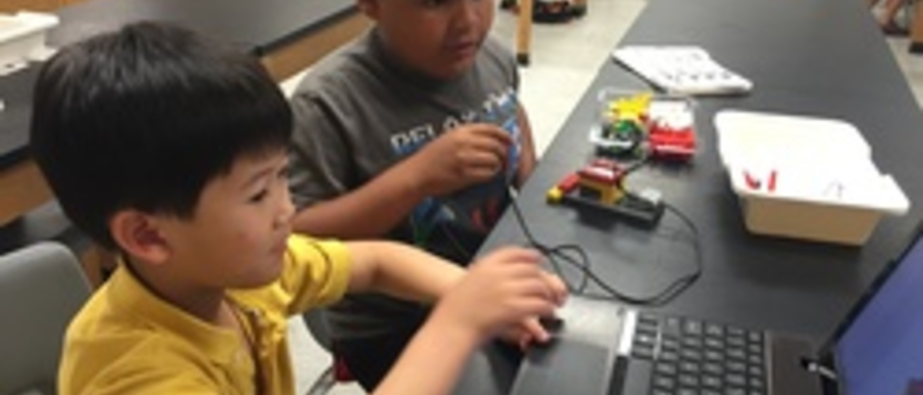 2 young boys doing a STEM activity