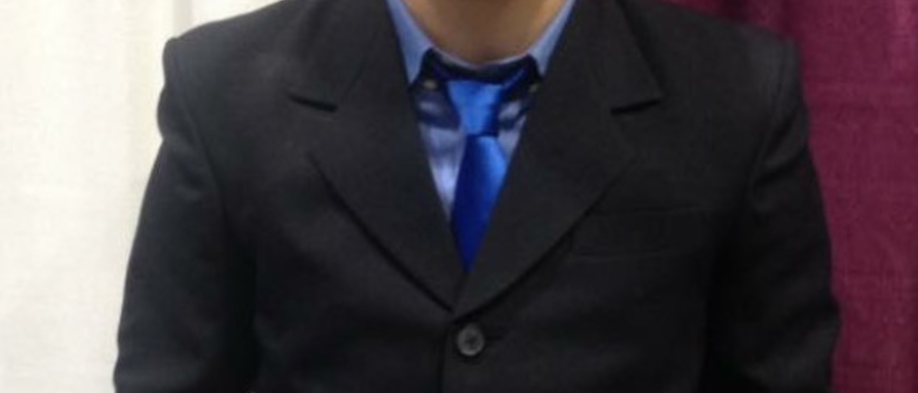 Esteban Londono, black jacket and blue shirt