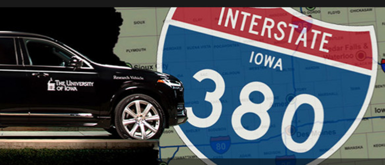 Photo of a car driving over a map of Iowa and an interstate 380 sign