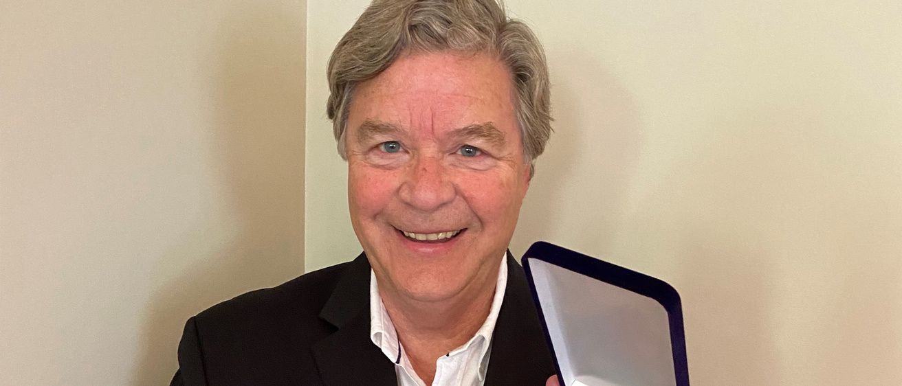 jerry schnoor holding medal