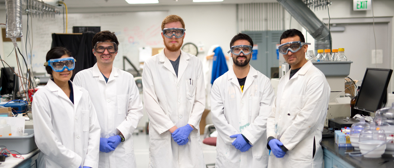 5 grad students in white lab coats