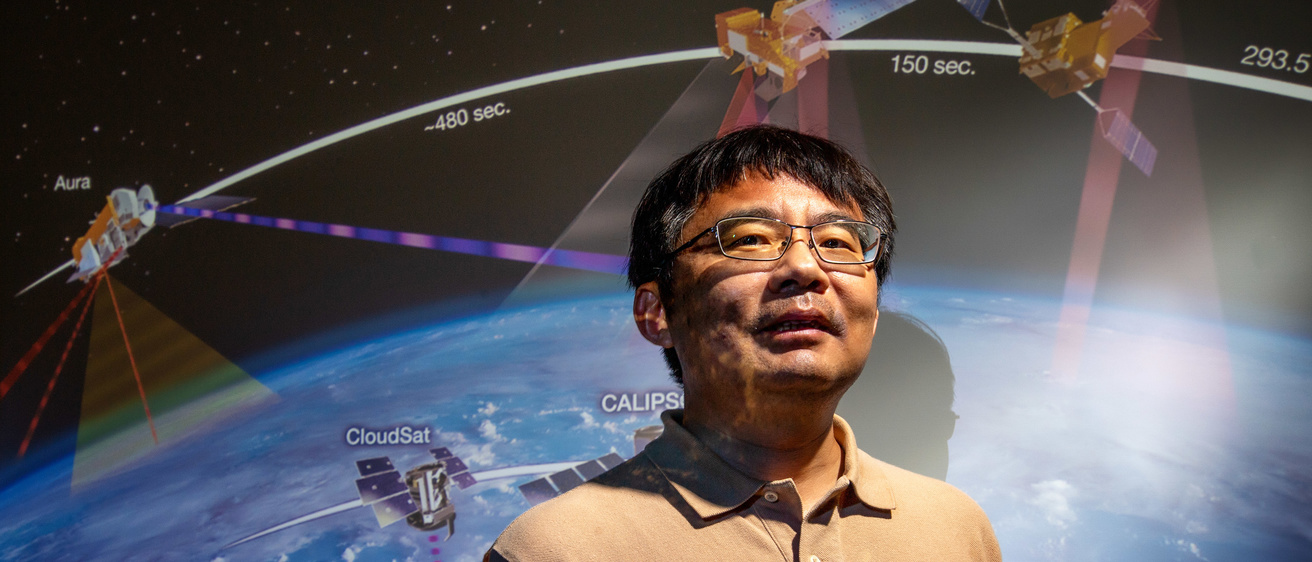 Jun wang standing in front of space background