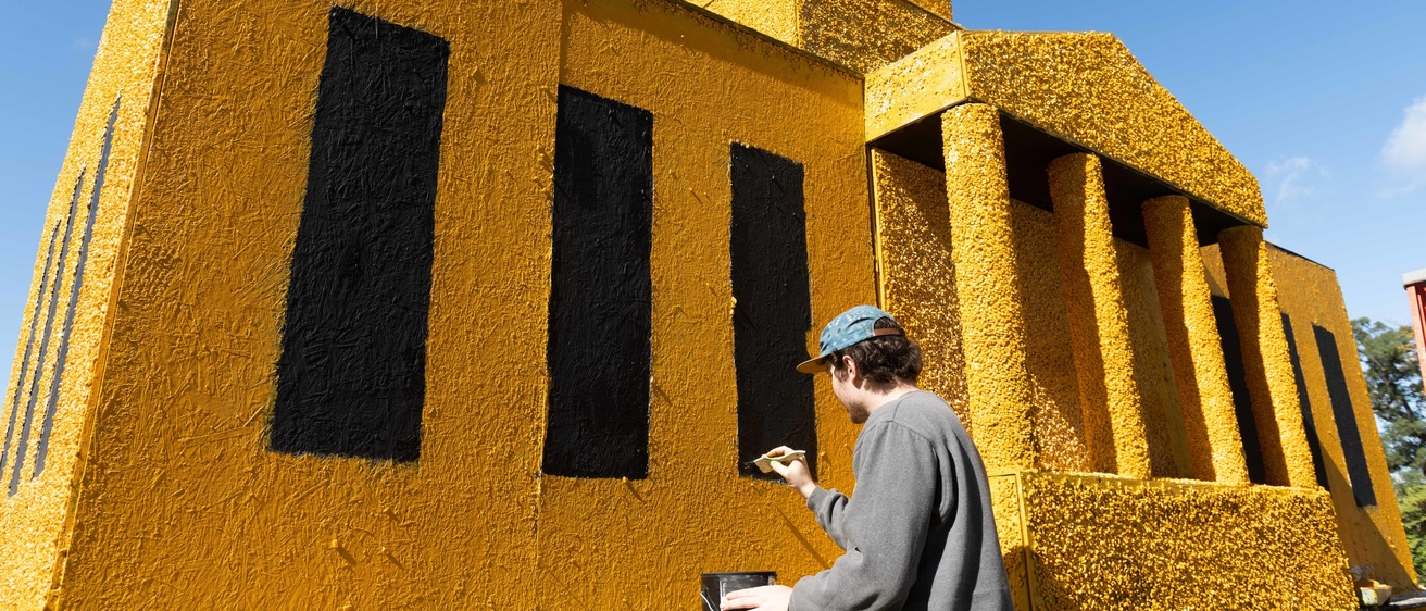 student painting corn monument