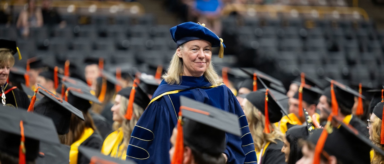 Ann McKenna stands among graduates at commencement