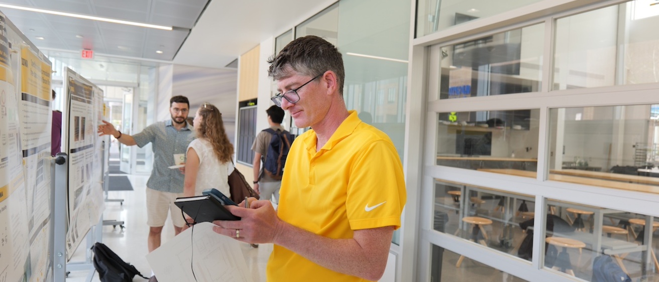 A person judging a research poster