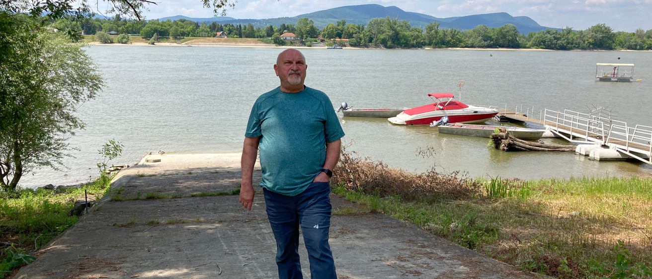 Muste stands on a boat ramp in front of a lake