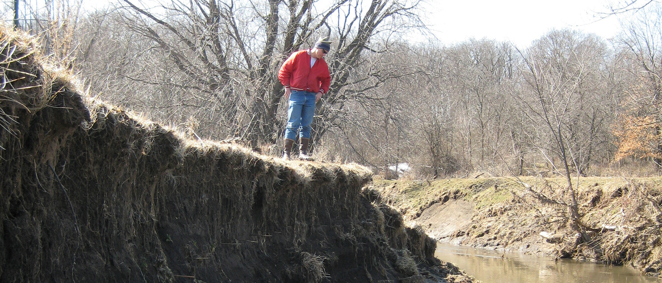 Keith Schilling stands overlooking a river