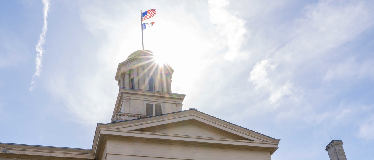 Capitol building with "Iowa" flags 