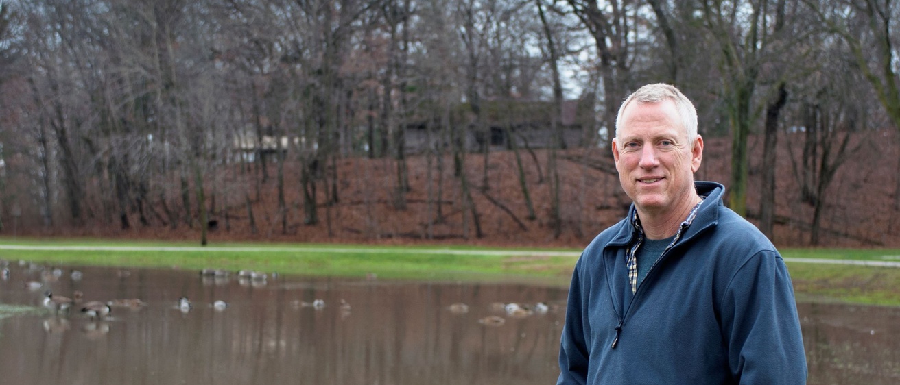 Photo of Keith Schilling standing in front of a body of water
