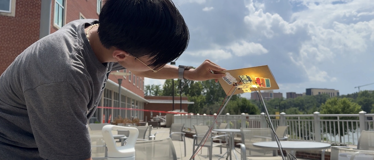 Leung observes the amount of light concentrated by his solar thermophotovoltaic system