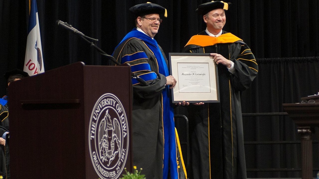 Man being presented a degree at the College of Engineering's undergraduate cmmencement