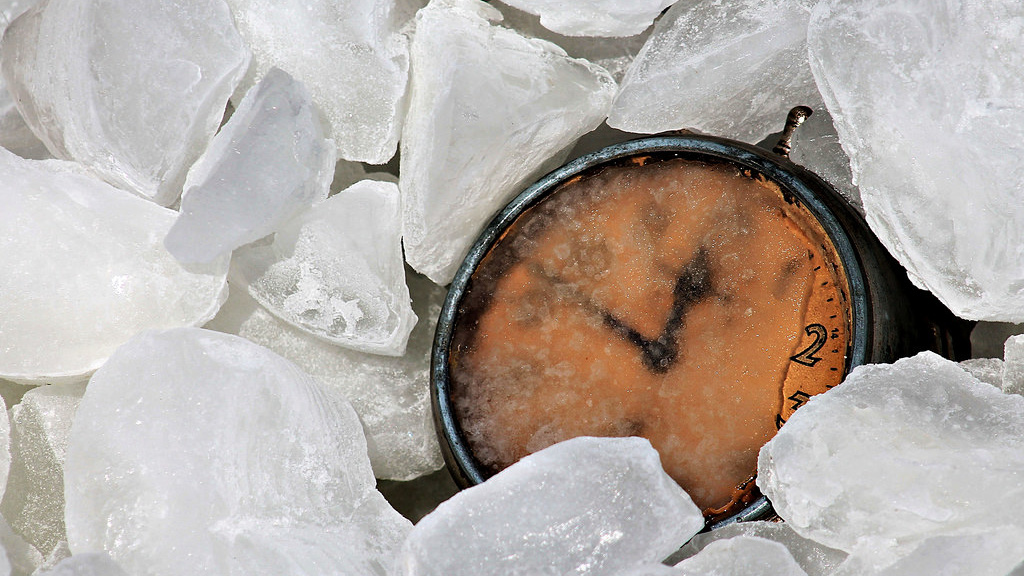 Clock covered by ice cubes